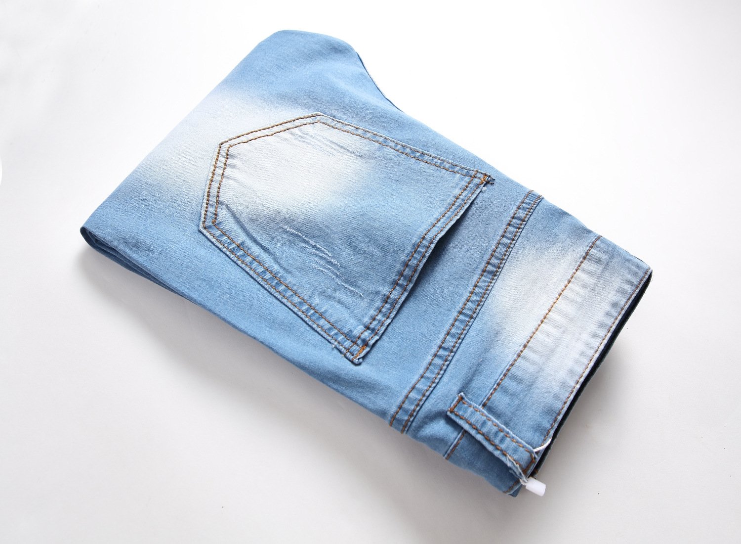 Мужские джинсы с разрывами и зауженными штанинами оптом из Китая