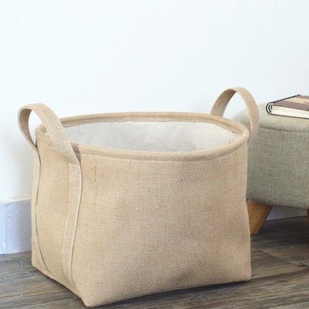 Желтая корзина для белья и вещей из хлопково-ленной ткани фотография