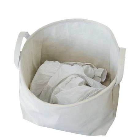 Желтая корзина для белья и вещей из хлопково-ленной ткани фотография